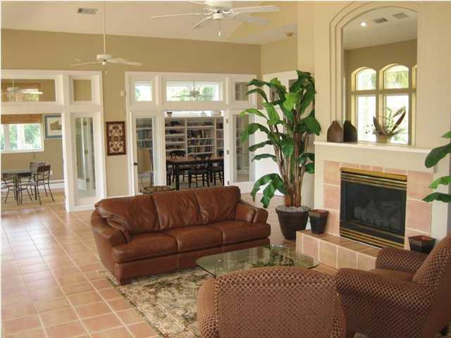 Lot 8 White Cliffs Boulevard Santa Rosa Beach, FL 32459 - Photo 12 of 23 a living room with furniture a flat screen tv and a fireplace