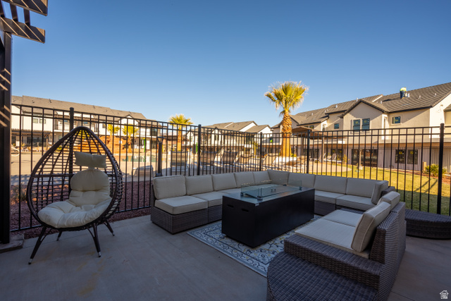 2600 Ocotillo Way, Unit 31 Santa Clara, UT 84765 - Photo 63 of 73 Spacious concrete patio featuring a black metal fence, a decorative pergola element, and partial views of surrounding properties