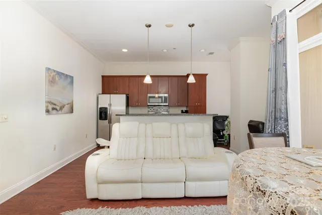 a living room with furniture and kitchen view
