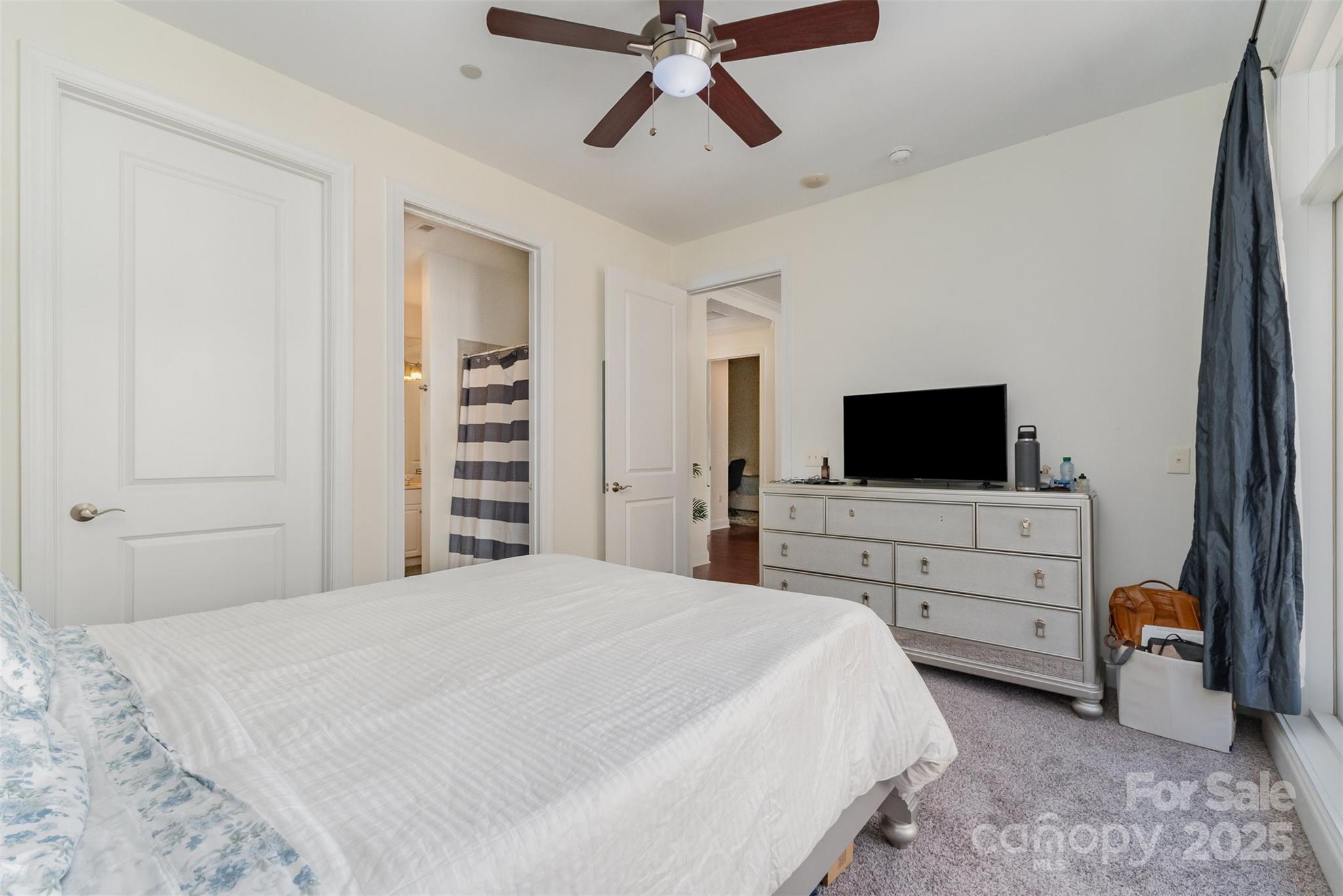 230 South Tryon Street, Unit 1105 Charlotte, NC 28281 - Photo 18 of 33 a bedroom with a bed and a flat screen tv