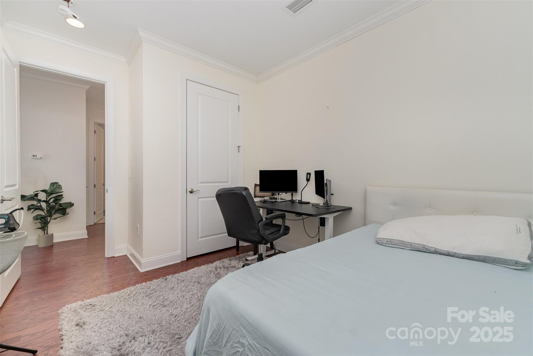 230 South Tryon Street, Unit 1105 Charlotte, NC 28281 - Photo 23 of 33 a bedroom with a bed and a table