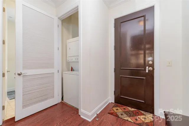 a view of walk in closet with wooden floor