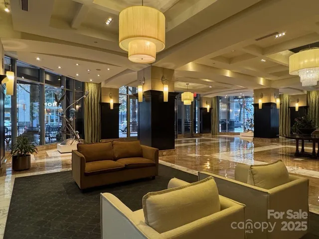 a view of a lobby with a couch and a chandelier