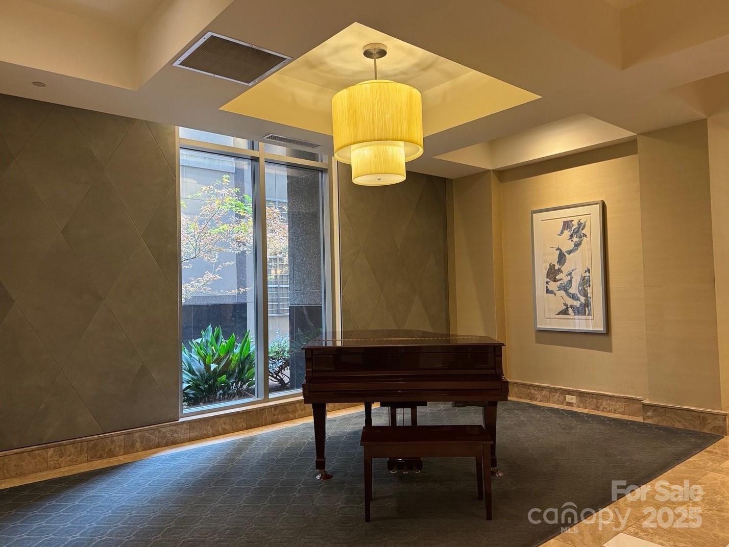 230 South Tryon Street, Unit 1105 Charlotte, NC 28281 - Photo 31 of 33 a room that has a table and a chandelier