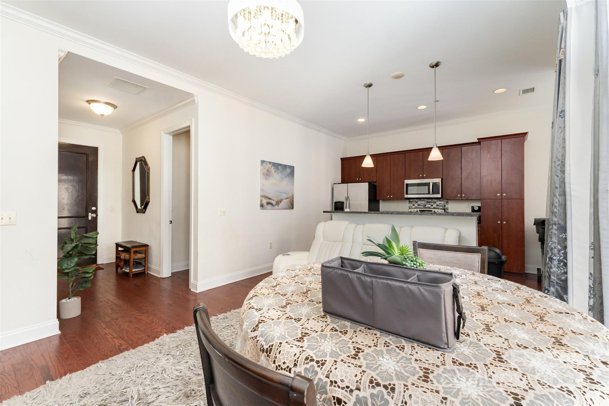230 South Tryon Street, Unit 1105 Charlotte, NC 28281 - Photo 9 of 33 a living room with furniture and wooden floor
