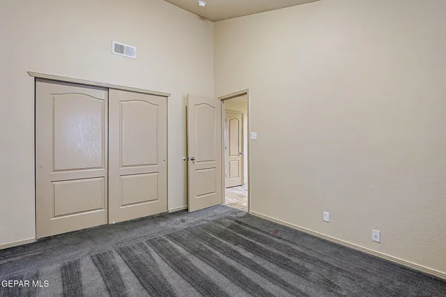 a bedroom with a large bed and a potted plant
