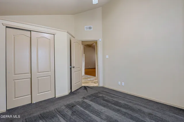 a bathroom with a granite countertop sink a toilet a mirror and bathtub