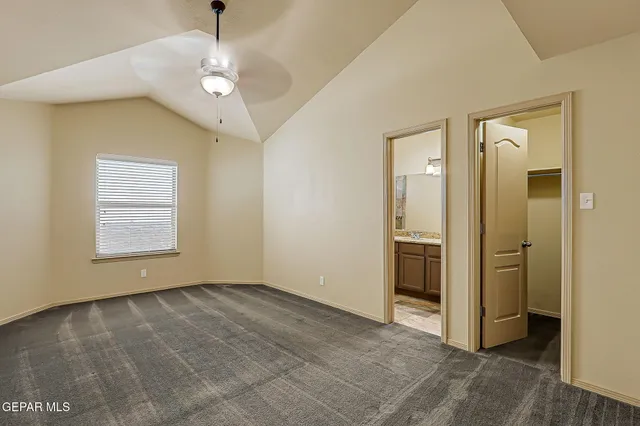 a bathroom with a granite countertop sink a toilet and a mirror