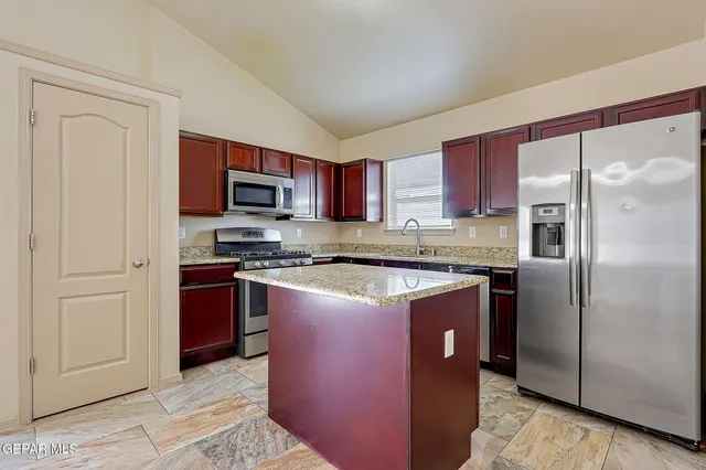 a kitchen with stainless steel appliances granite countertop a sink stove and cabinets