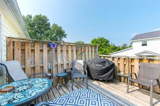 a view of a patio with table and chairs potted plants with wooden floor
