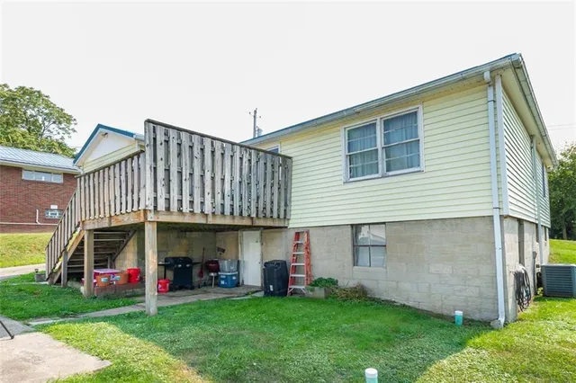 a view of a house with a garden and deck