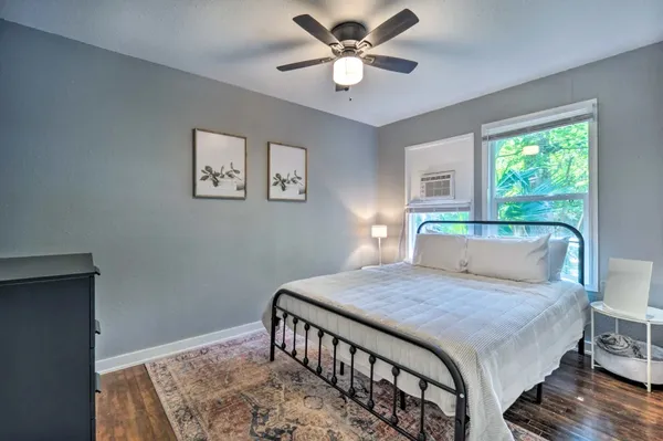 a bathroom with a sink a toilet a mirror and shower