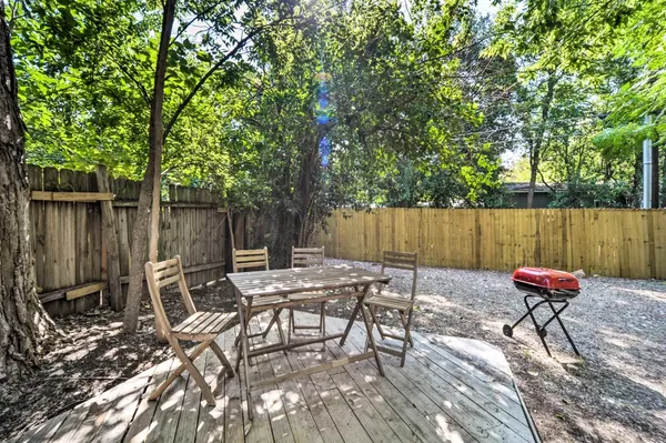 an empty room with wooden floor ceiling fan and windows
