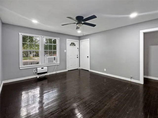a kitchen with granite countertop white cabinets and a sink