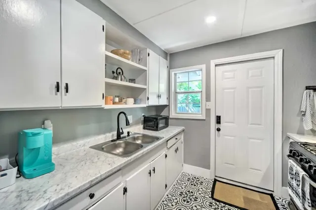 a kitchen with a sink stove and cabinets
