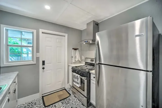 a kitchen with a refrigerator and a stove top oven