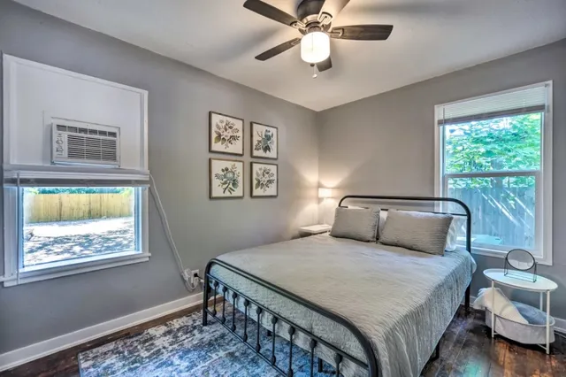 a bedroom with a bed and a chandelier