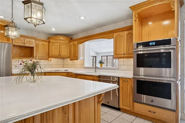 a kitchen with stainless steel appliances a stove a sink and a microwave