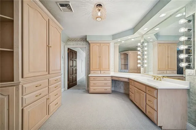 a large white kitchen with a large window