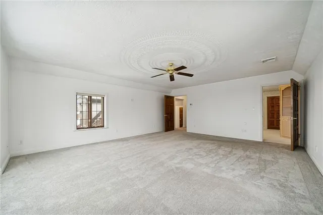 a view of an empty room with a ceiling fan