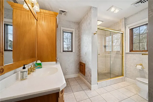 a bathroom with a sink toilet and shower