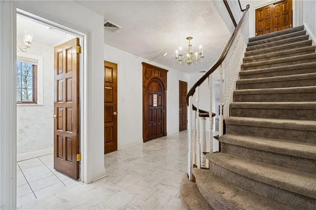 a view of staircase with lots of frames and stairs