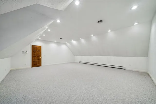 an empty room with a projector and white walls