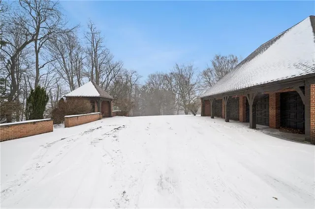 a view of a house with snow on the road