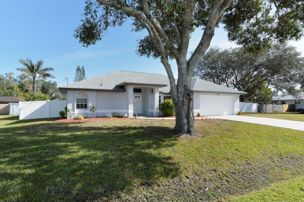 3087 Odessa Road Venice, FL 34293 - Photo 1 of 1 a front view of a house with a garden and trees