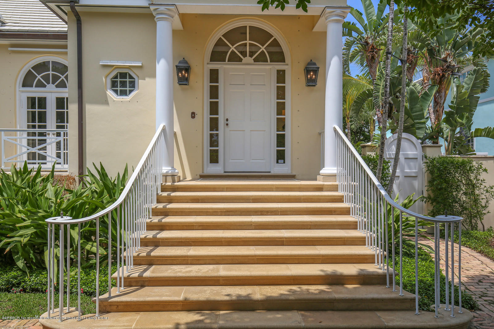 133 Gulfstream Road Palm Beach, FL 33480 - Photo 2 of 20 a view of a brick house with a large windows stairs and a large tree