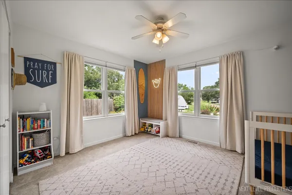 a view of an empty room with a window and a livingroom with furniture