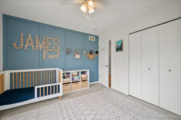 a bedroom with furniture and a book shelf