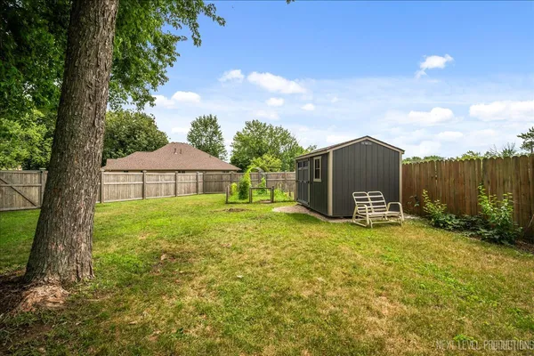 a view of a barn in the middle of a garden