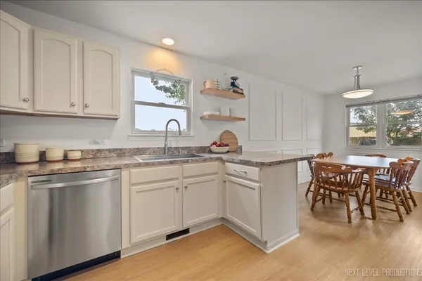 a kitchen with sink and cabinets