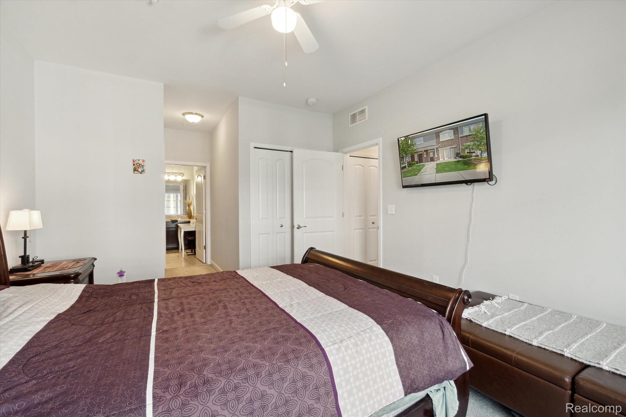 5662 Arbor Chase Drive Ann Arbor, MI 48103 - Photo 20 of 27 Bedroom featuring light gray walls and a ceiling fan