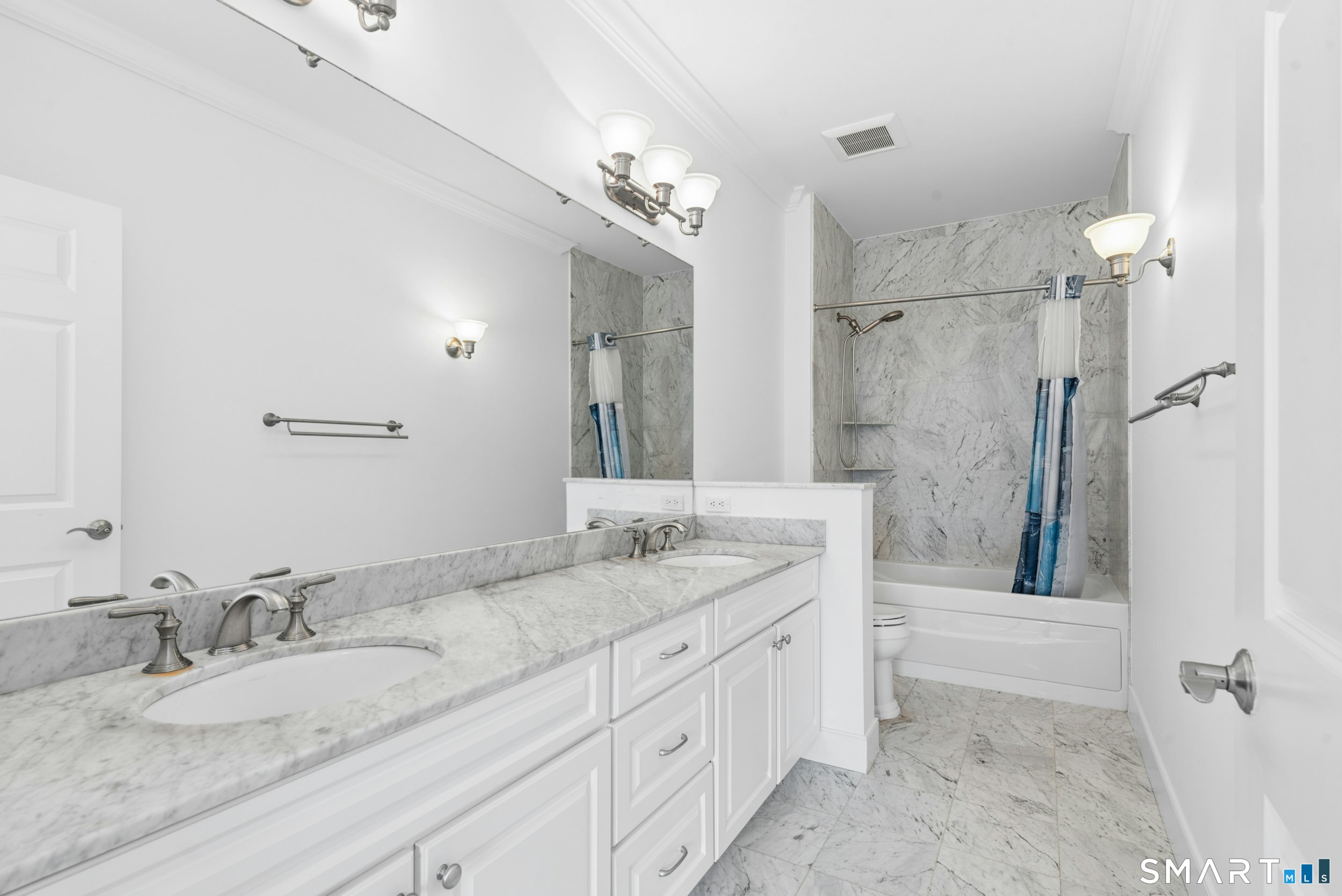 77 Havemeyer Lane, Unit 310 Stamford, CT 06902 - Photo 13 of 22 a bathroom with a granite countertop sink a mirror and a shower