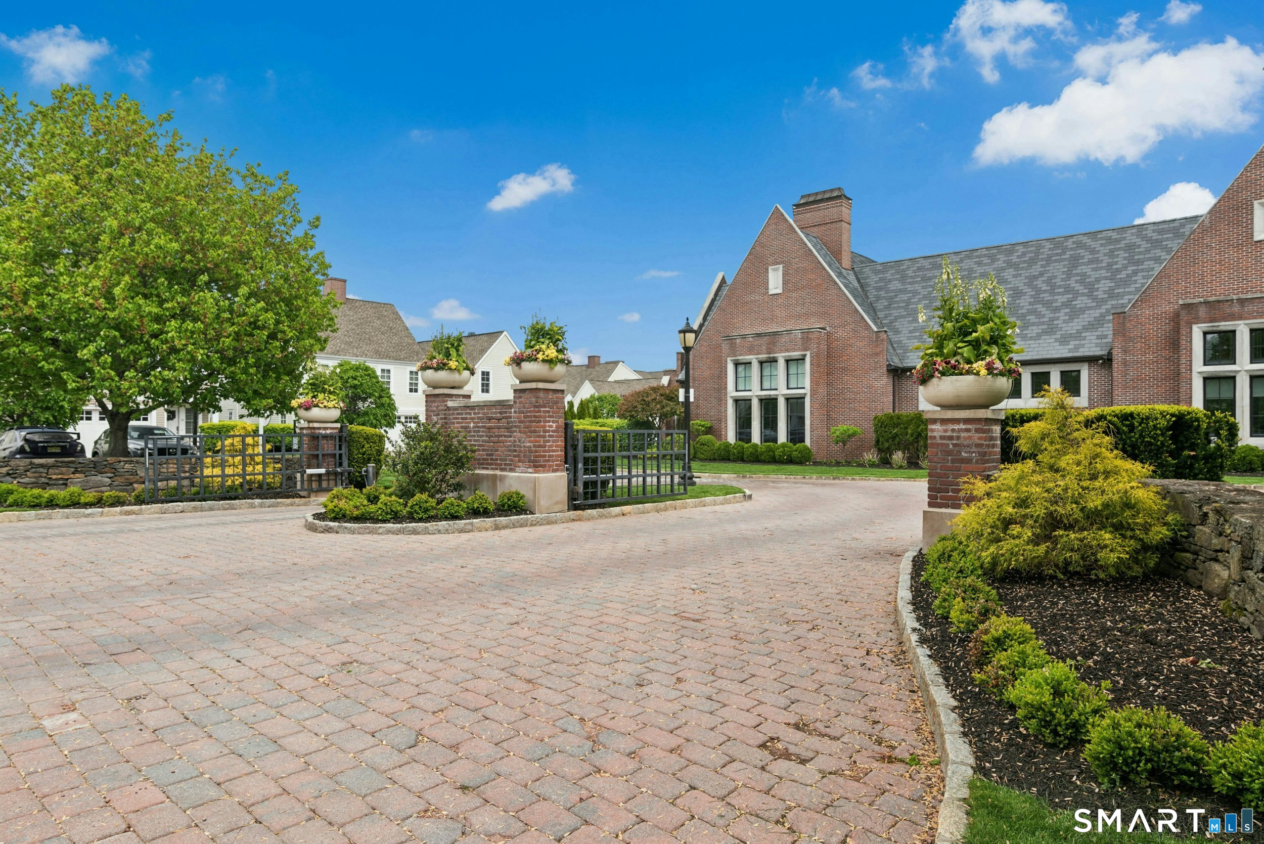 77 Havemeyer Lane, Unit 310 Stamford, CT 06902 - Photo 2 of 22 a front view of a house with a yard and potted plants