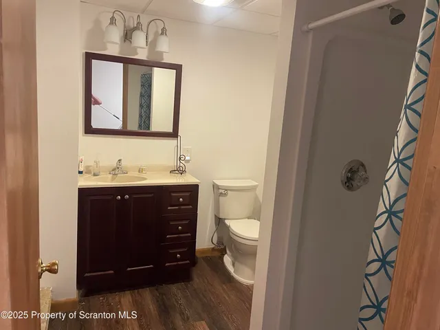 a bathroom with a sink vanity mirror and toilet