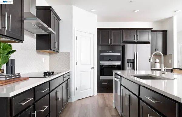 a kitchen with a sink cabinets and stainless steel appliances