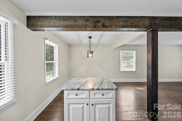 a kitchen with a stove a sink and a window