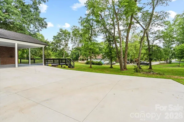 a view of a park with plants and large trees