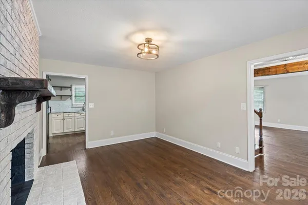 wooden floor in an empty room with a fireplace