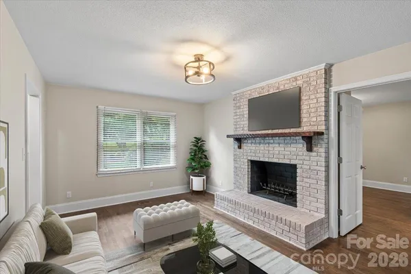 a living room with furniture a rug and a fireplace