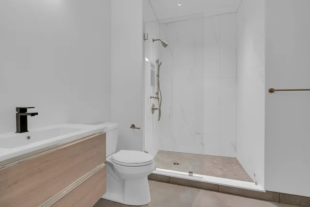 a bathroom with a toilet sink and a shower