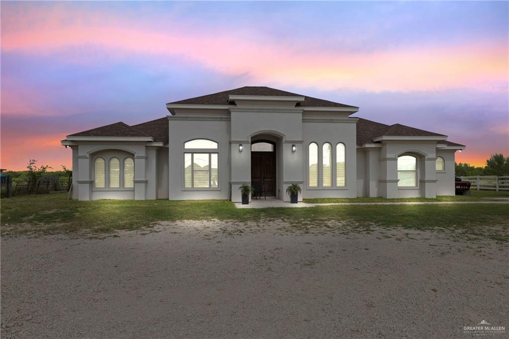 Mediterranean / spanish home featuring stucco siding and a shingled roof