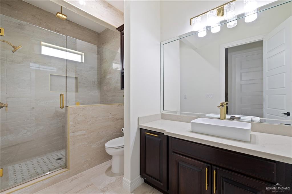 22303 Uresti Road Edinburg, TX 78542 - Photo 11 of 22 Full bathroom featuring vanity and a stall shower