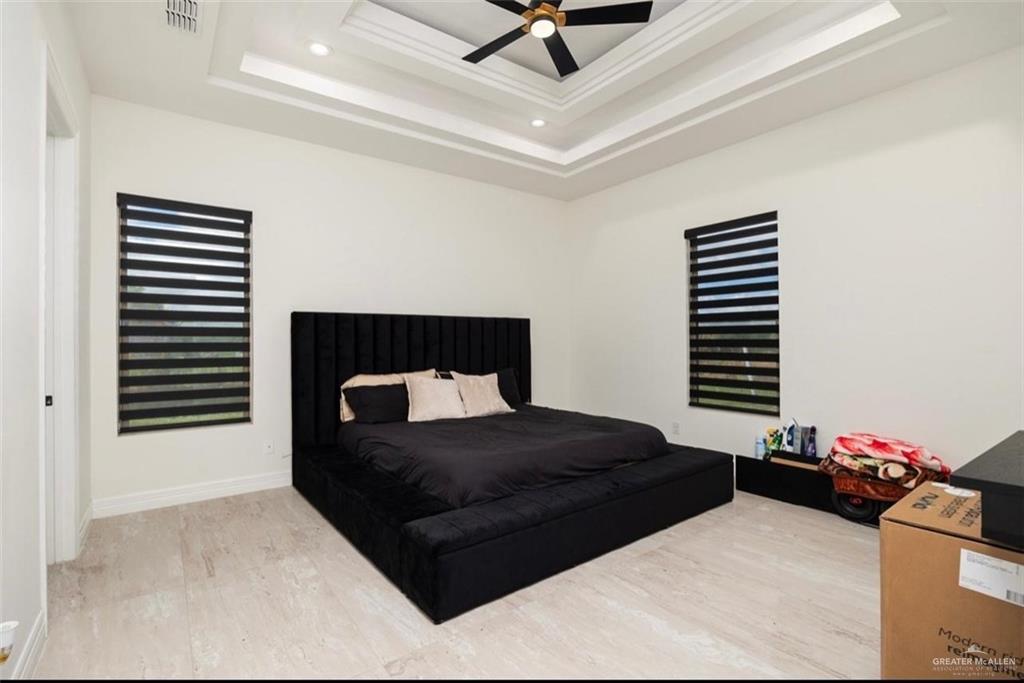 22303 Uresti Road Edinburg, TX 78542 - Photo 15 of 22 Bedroom featuring a raised ceiling, recessed lighting, and ceiling fan