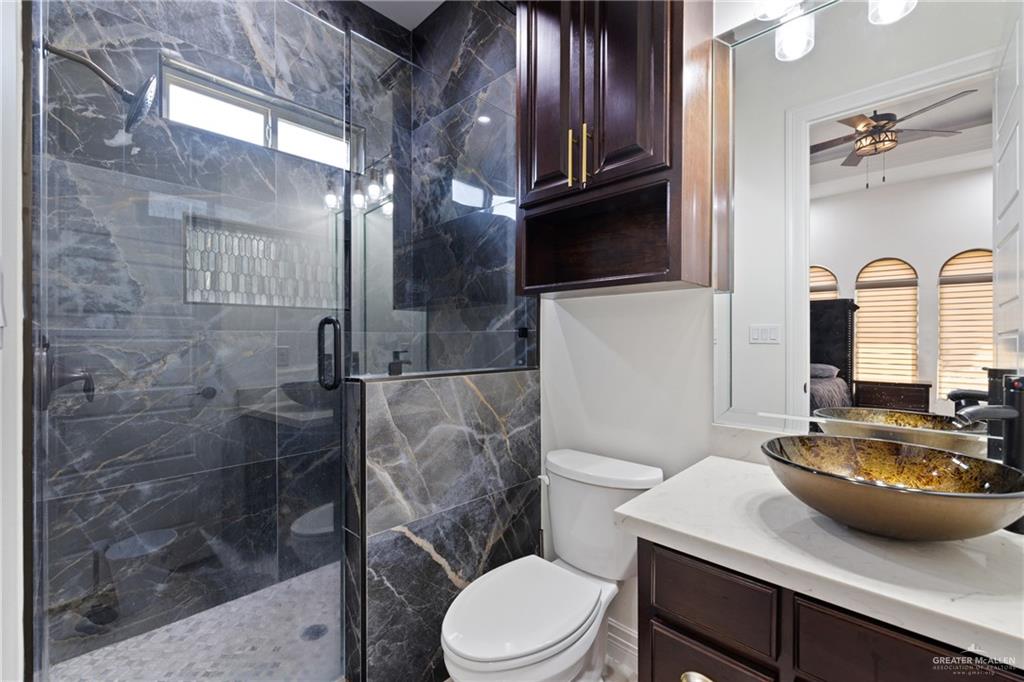 22303 Uresti Road Edinburg, TX 78542 - Photo 16 of 22 Bathroom featuring vanity, a shower stall, ceiling fan, and ensuite bathroom