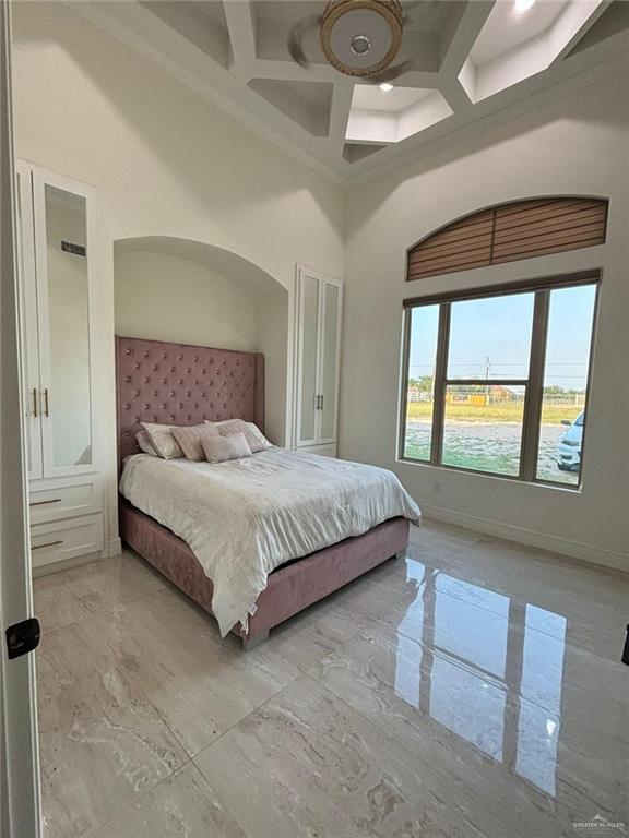 22303 Uresti Road Edinburg, TX 78542 - Photo 17 of 22 Bedroom with light marble finish flooring, coffered ceiling, a towering ceiling, beamed ceiling, and ornamental molding