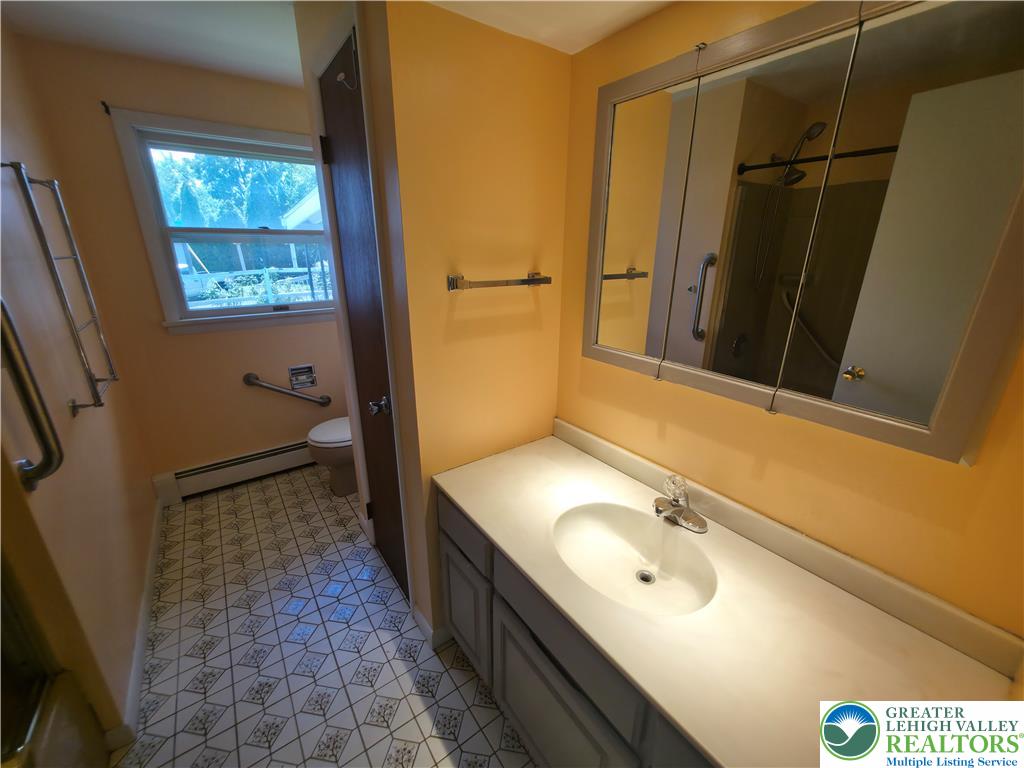 719 Keystone Avenue Bethlehem, PA 18018 - Photo 17 of 32 A window-lit bathroom offers practicality and classic patterned flooring.
